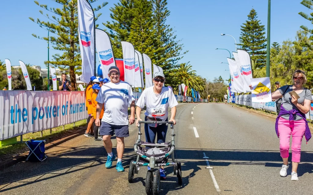 photo of woman using walking aid completing a race